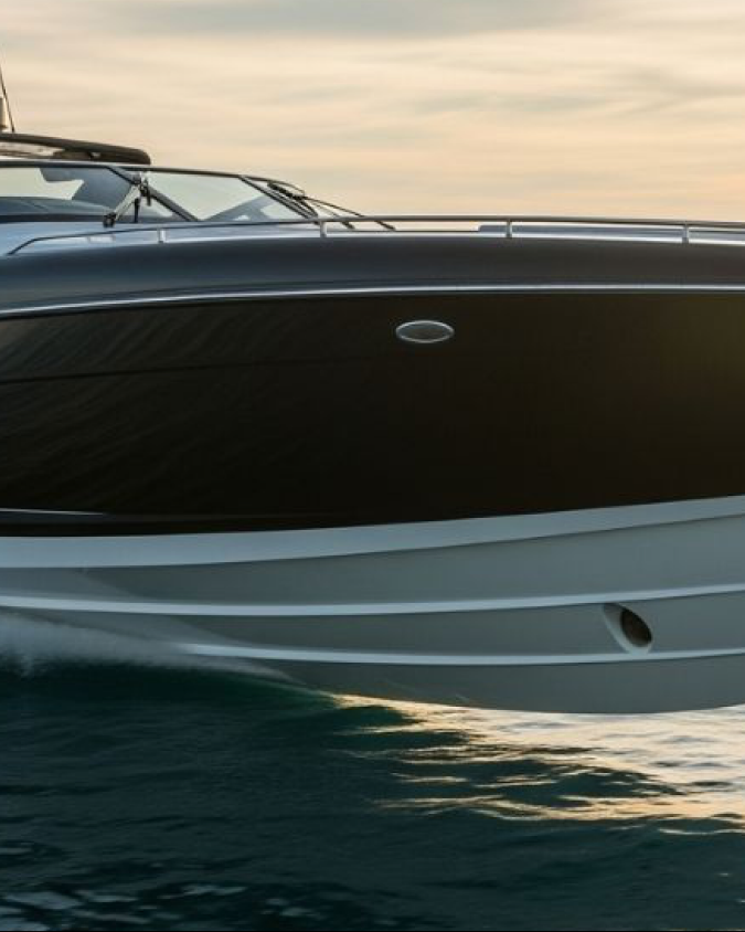 Powerboat cruising at sunset under a concierge ownership structure