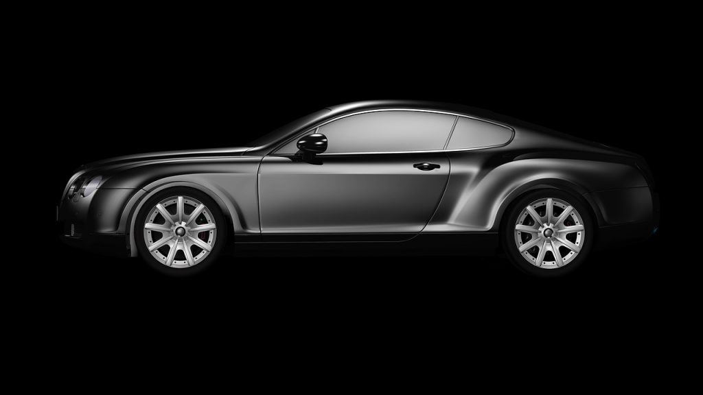 The image shows a sleek, high-end black coupe-style car viewed from the side against a solid black background.