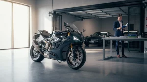Sleek dark blue sport motorcycle in the foreground of a showroom, with a businesswoman in a suit reviewing documents at a desk in the background.